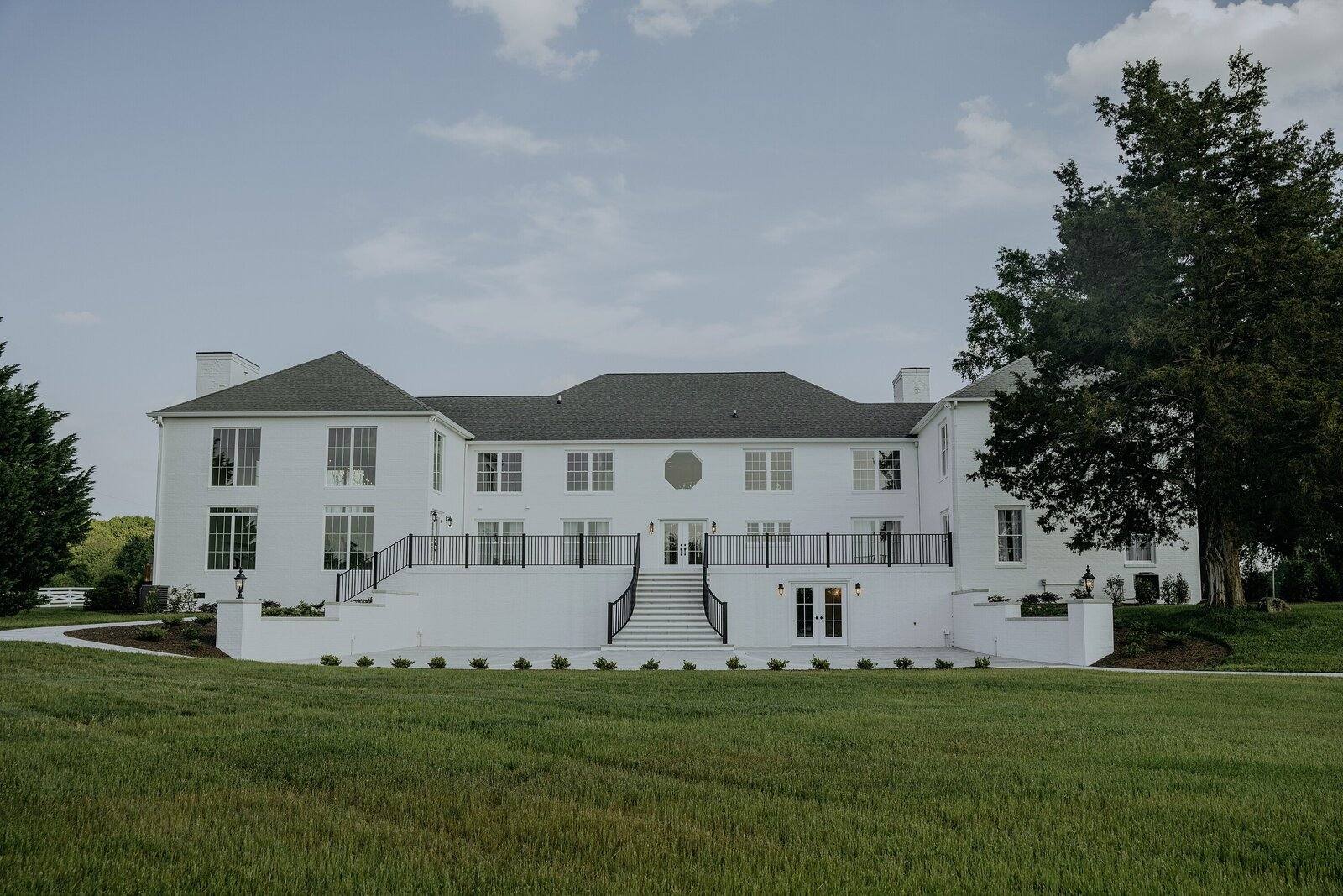 The white manor house across the lawn at Northfield Estate